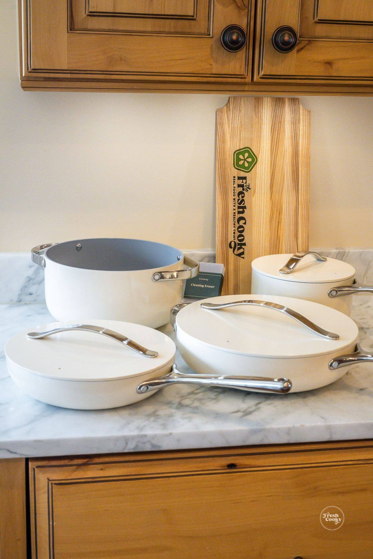 Caraway pots and pans with lids, trivets and cleaning sponge.