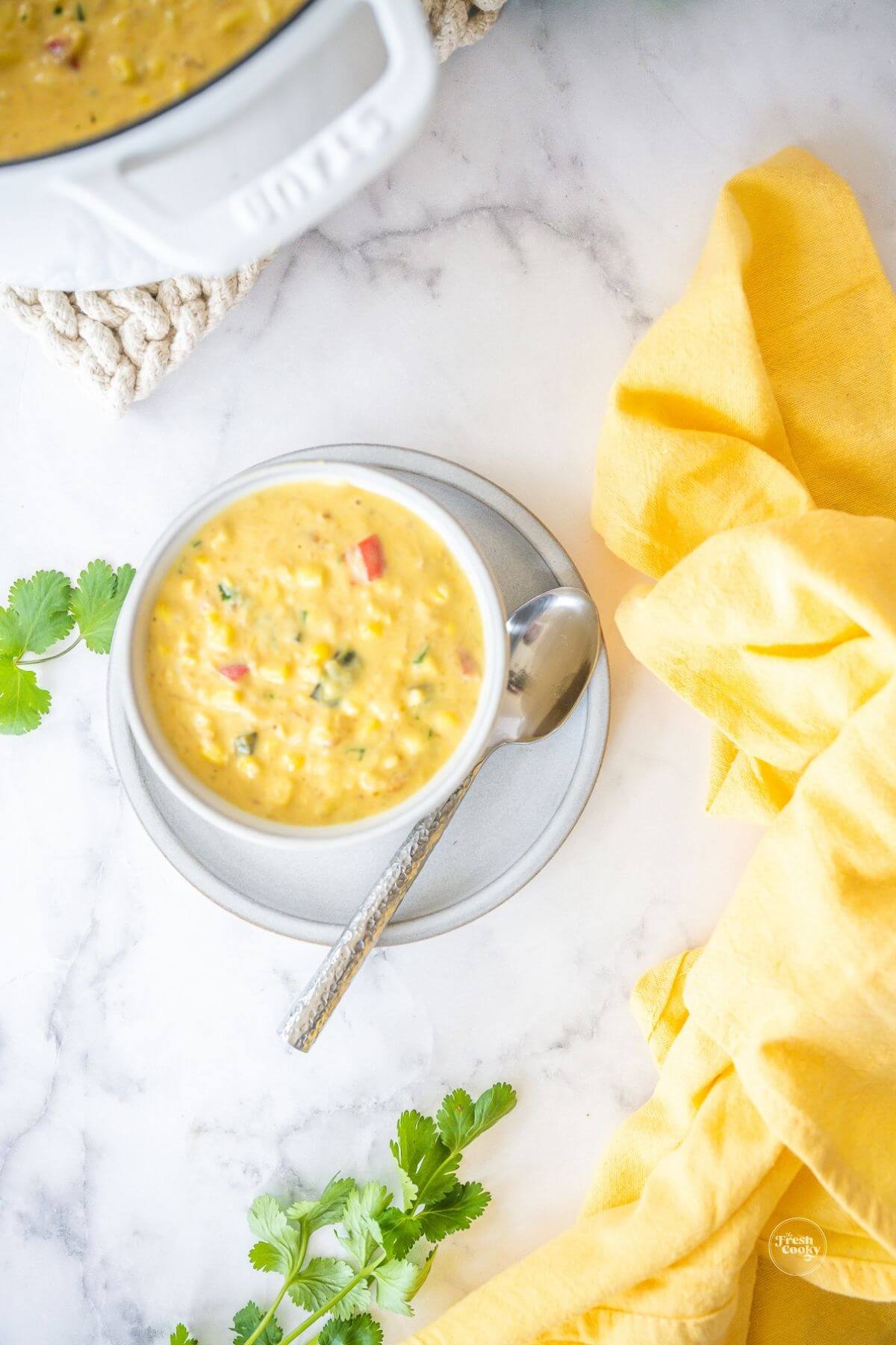 Bowl full of summer corn chowder, copycat Panera recipe in bowl with soup pot behind.