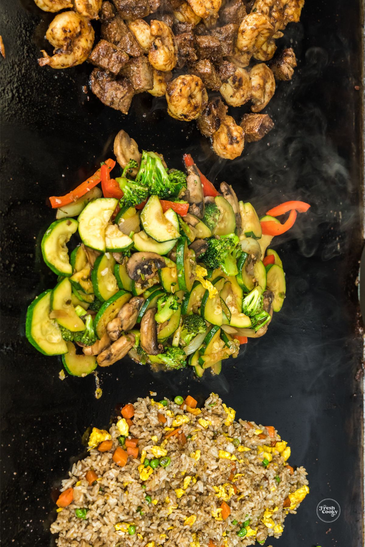 Hibachi steak and shrimp, with vegetables and fried rice on Blackstone griddle.