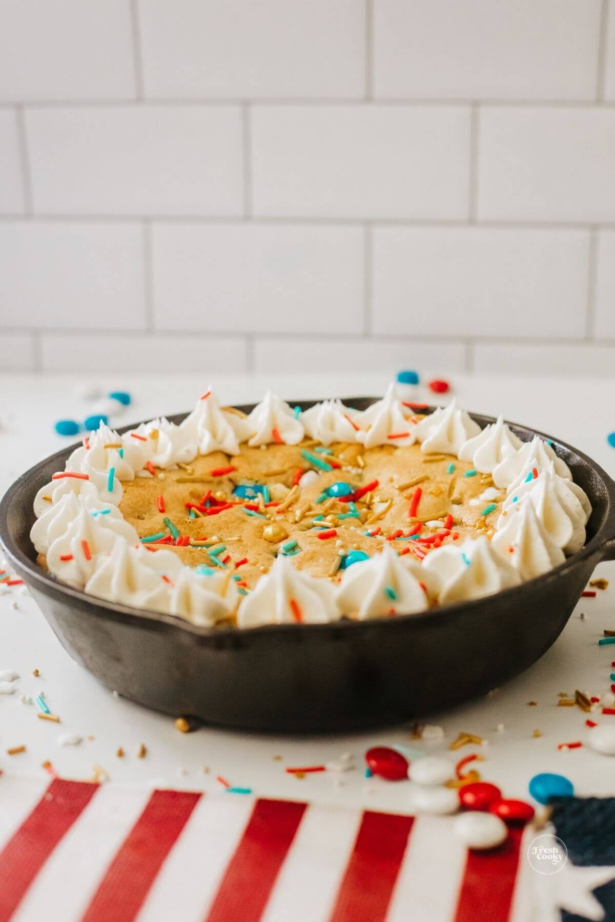 4th of July cookie cake in skillet decorated with frosting.