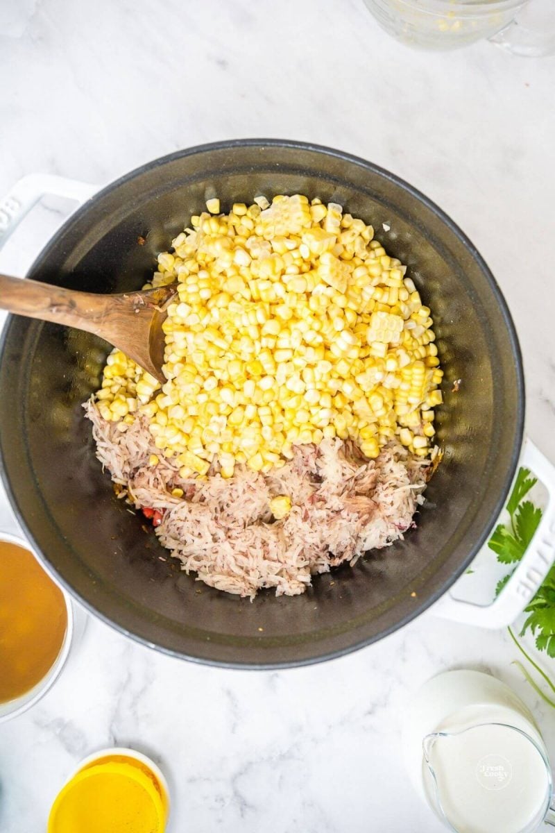 Add corn and shredded or diced potatoes to soup pot. 