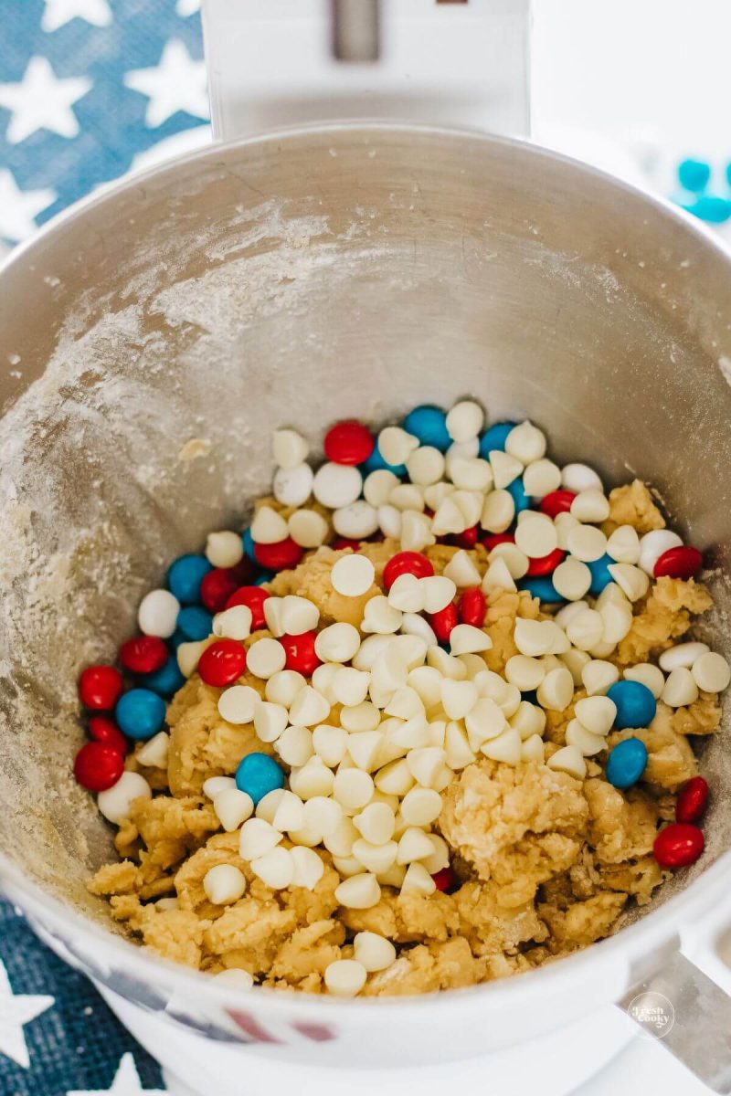 Adding mix-ins to patriotic cookie cake batter. 