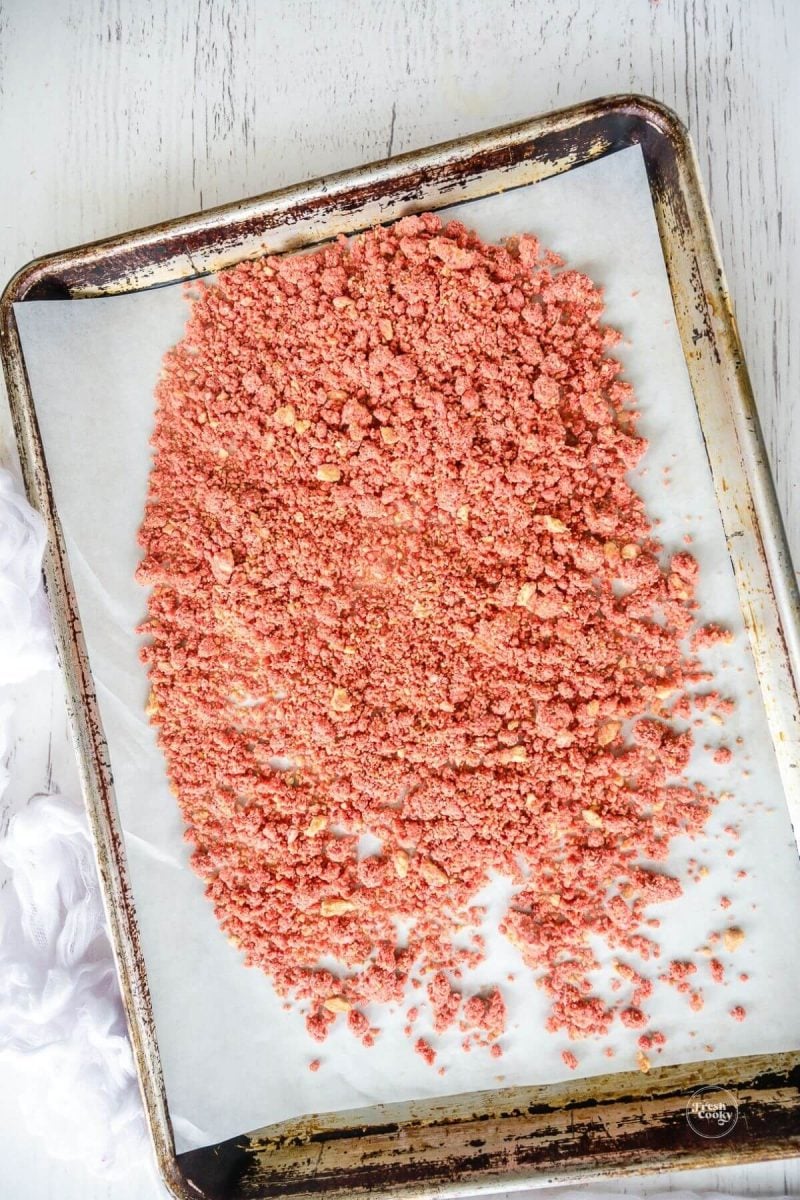 Unbaked strawberry crumble topping on baking sheet.