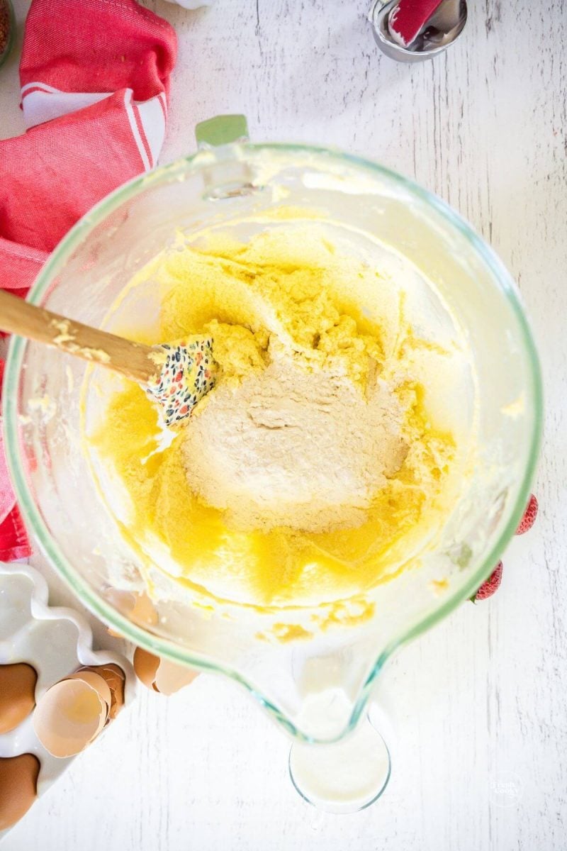 Add a little flour at a time to strawberry cake batter. 