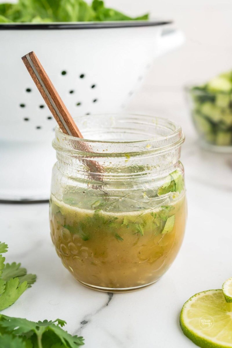 Mexican Salad Dressing honey lime dressing in jar with spoon.