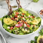 Healthy Mexican salad recipe in large bowl with serving tongs.