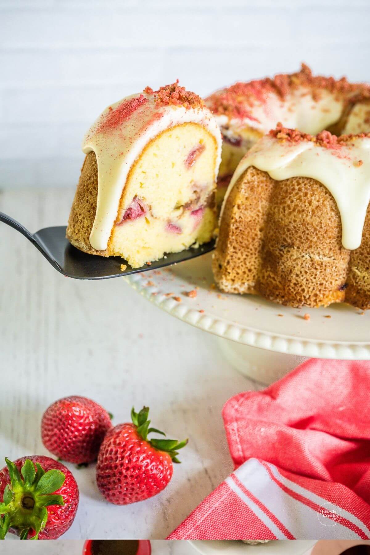 Removing a slice from the strawberry bundt cake.
