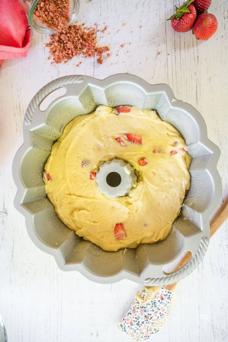 Smooth batter into prepared bundt pan.