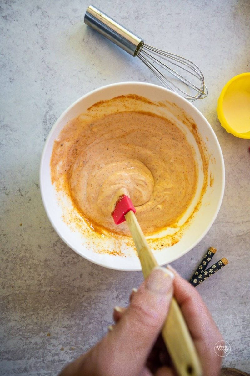 Mixing yum yum sauce in small bowl.