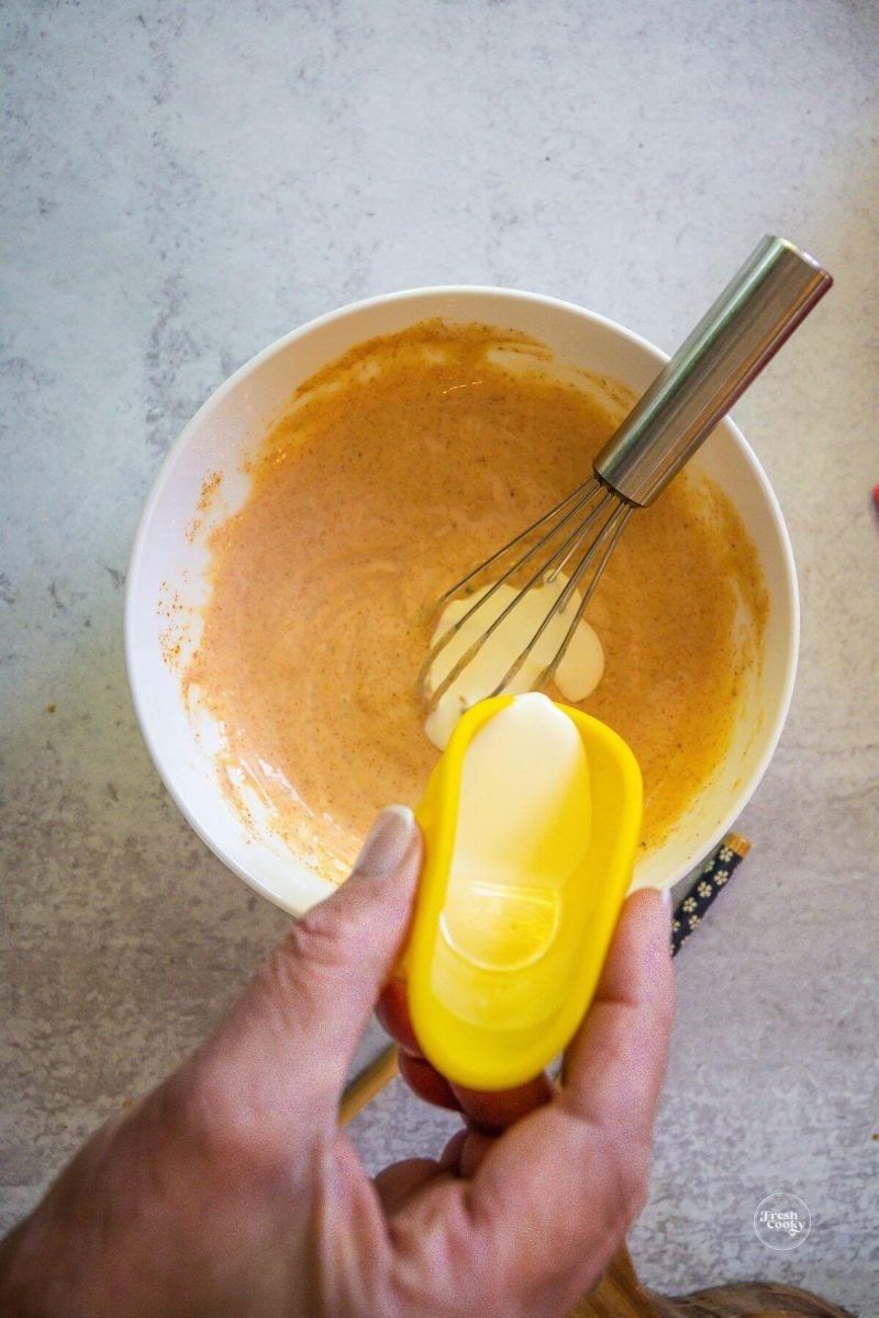Add a little cream to the yum sauce at a time, whisking between.