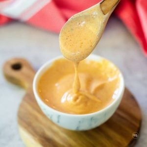 Easy Japanese Yum yum sauce, in small marble bowl, with wooden spoon.