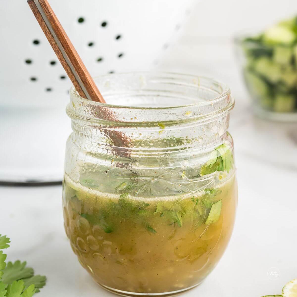 Honey lime dressing with cilantro in a mason jar.