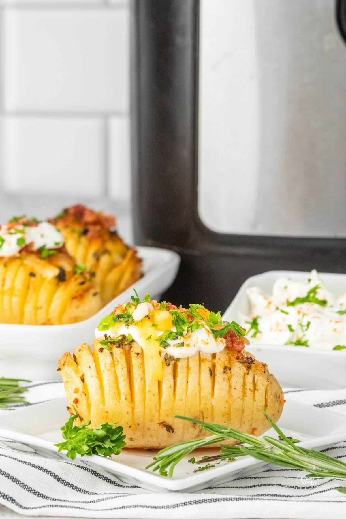 Hasselback potatoes in front of air fryer.