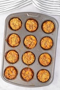 Mini apple pies in muffin tin, baked.