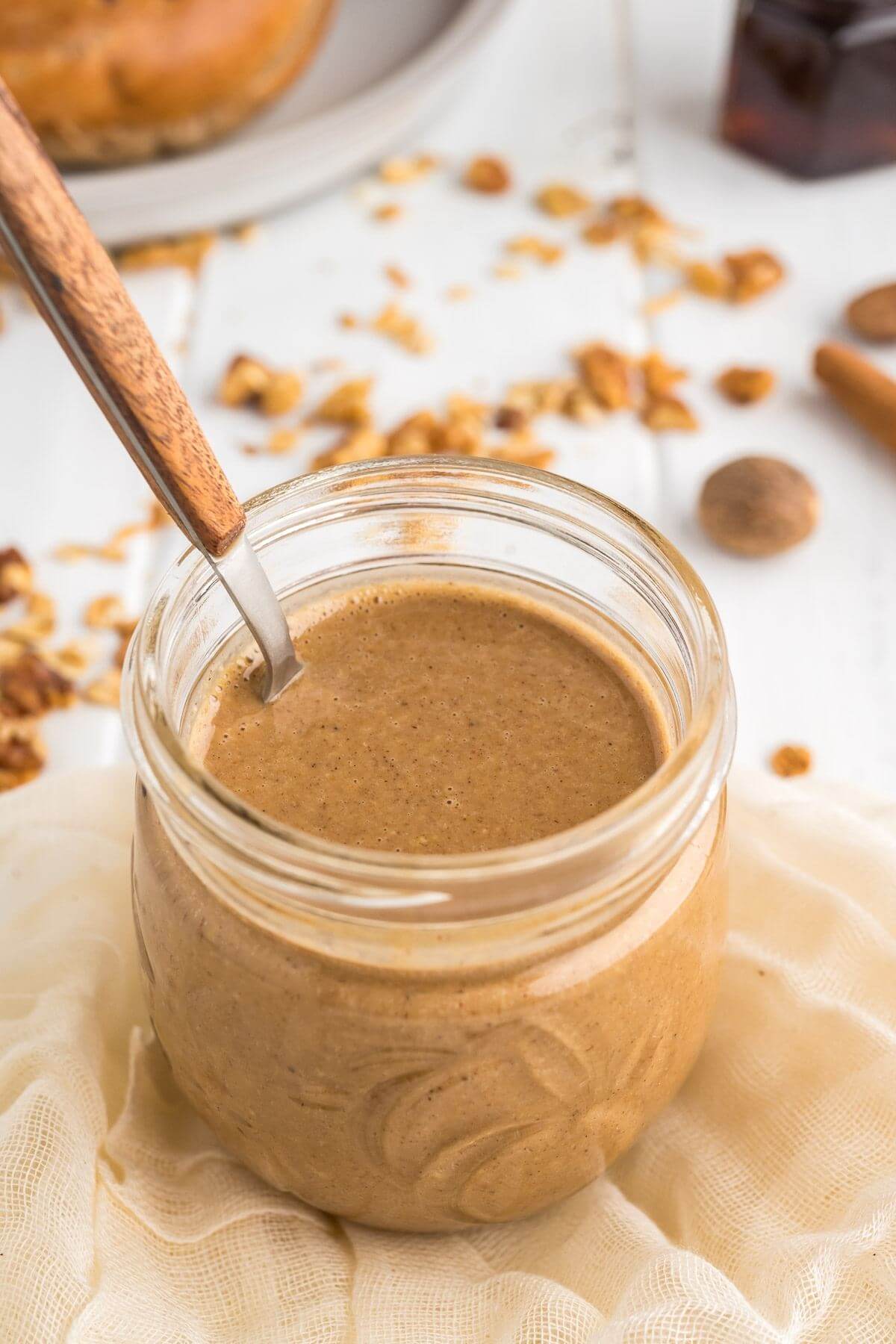 Granola butter in jar with a spoon.
