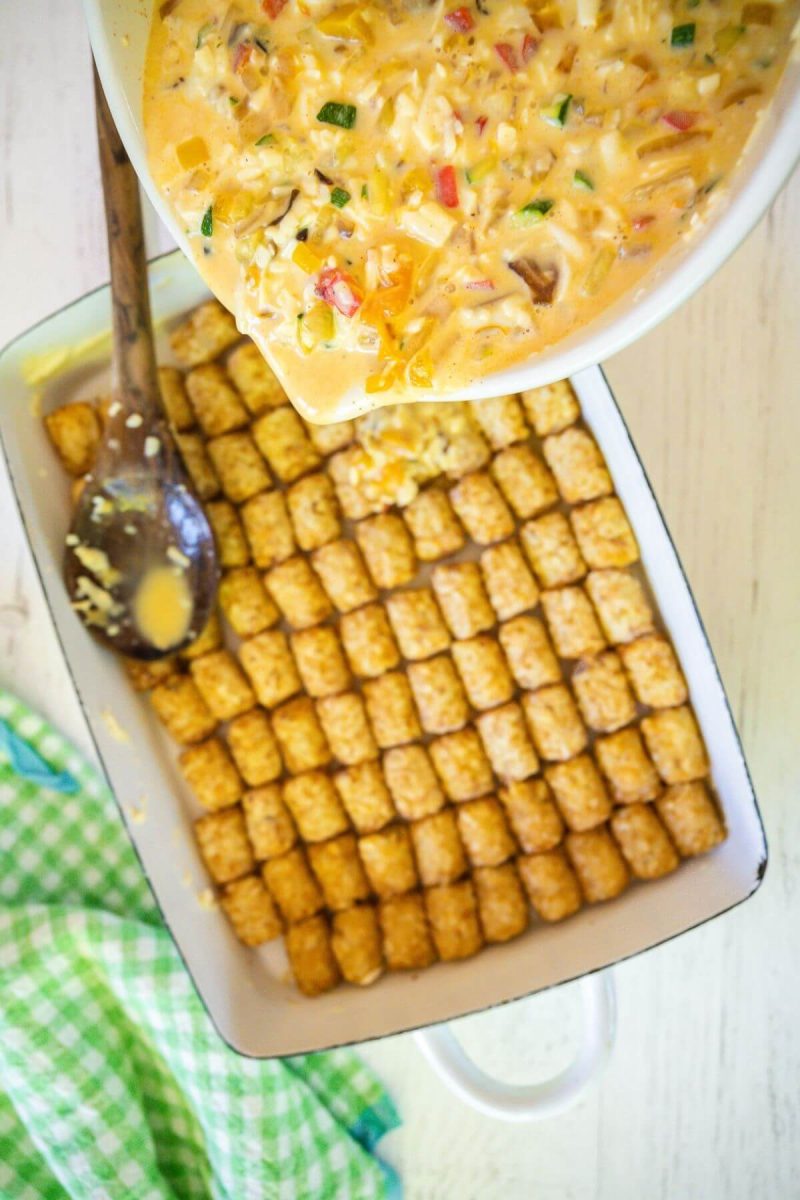 Pour egg and cheese mixture over tater tots and spread evenly.