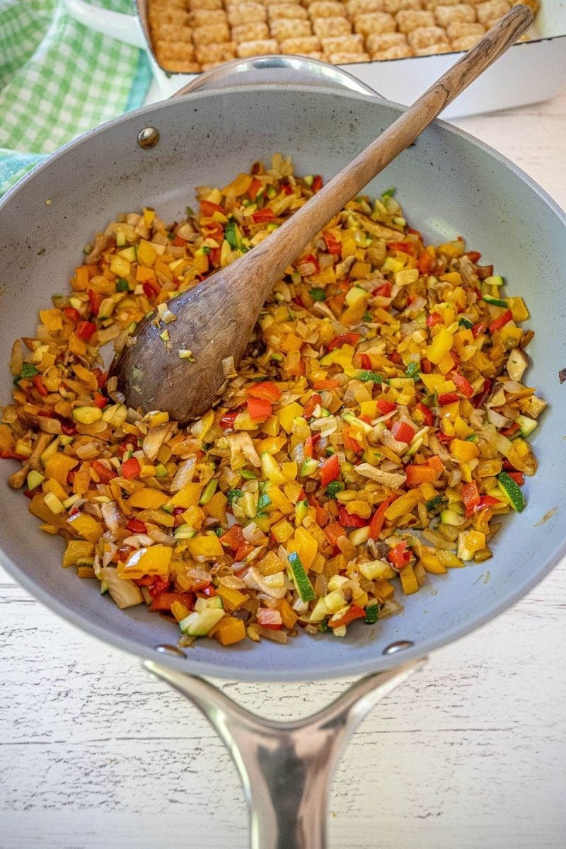 Sauted onions, peppers, zucchini, and mushrooms for tater tot casserole. 