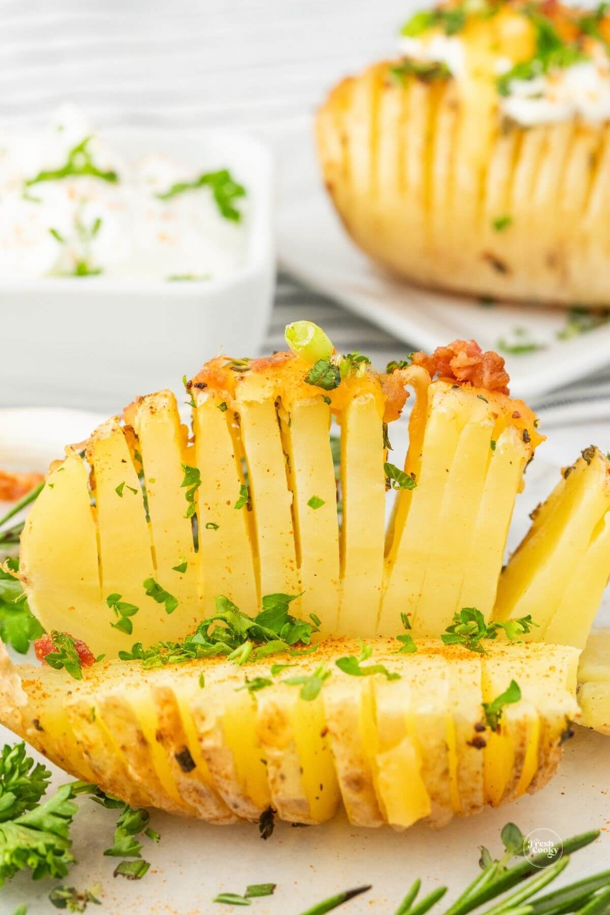 https://www.thefreshcooky.com/wp-content/uploads/2023/07/sliced-hasselback-potato-in-half.jpg