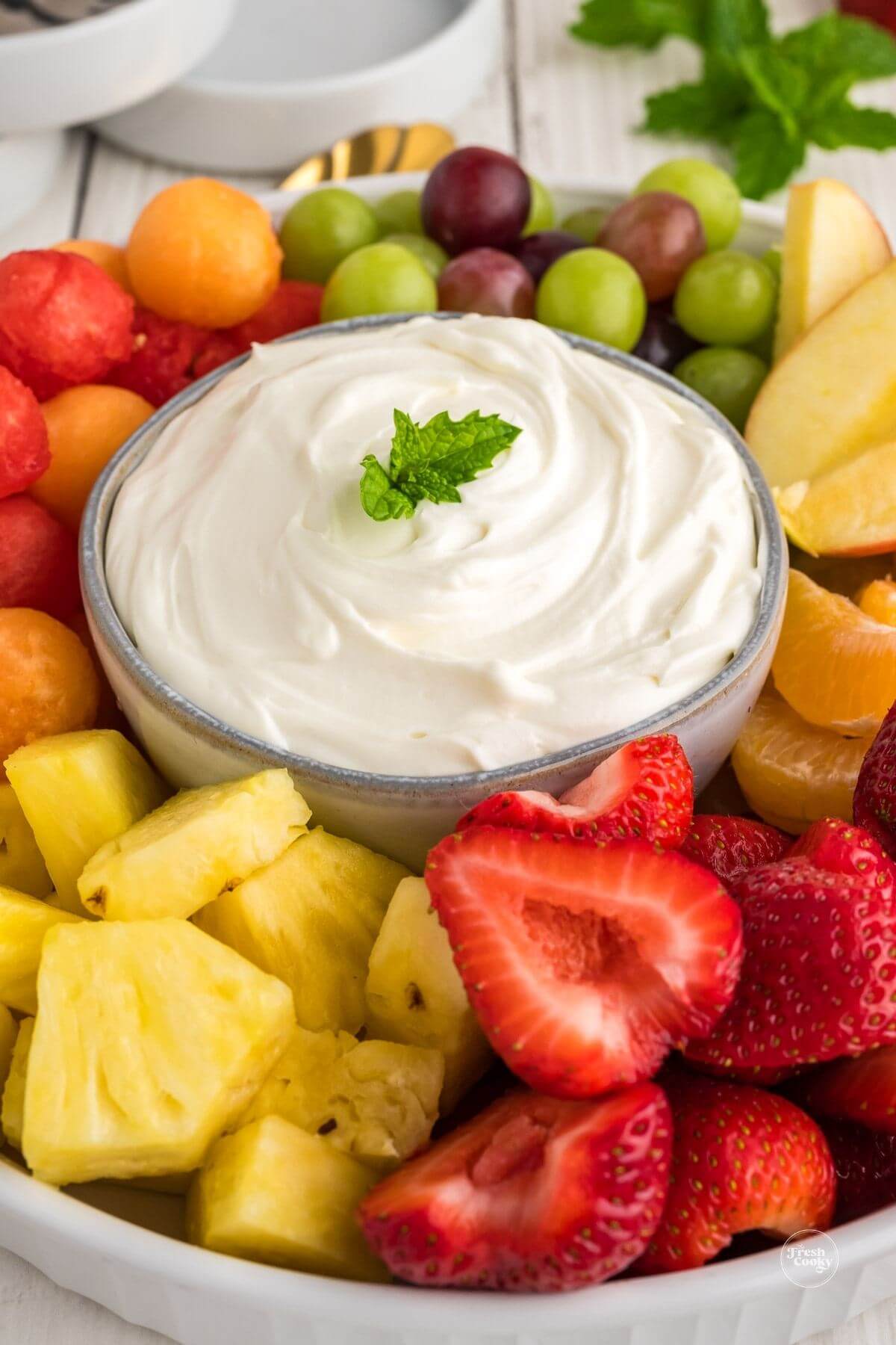 Healthy 3-ingredient fruit dip with cream cheese and surrounded by fresh fruit.