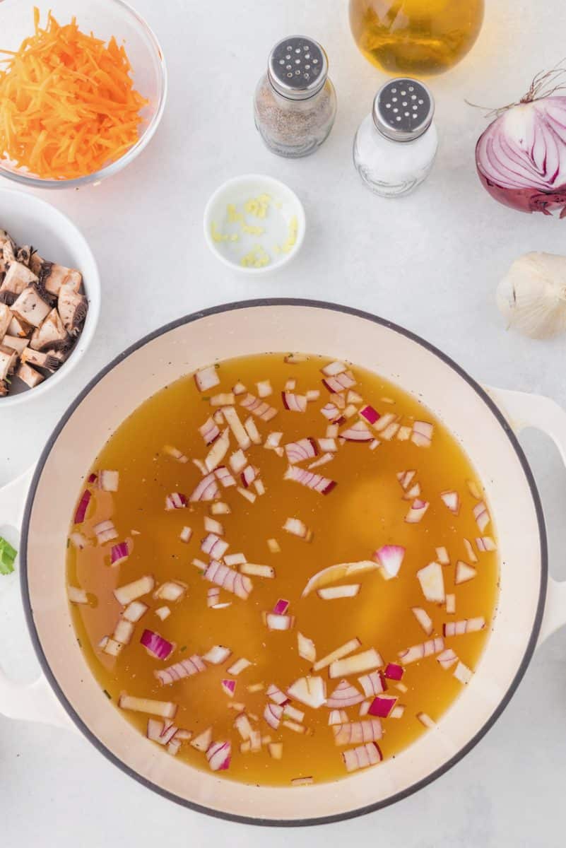 Adding chicken to the broth.