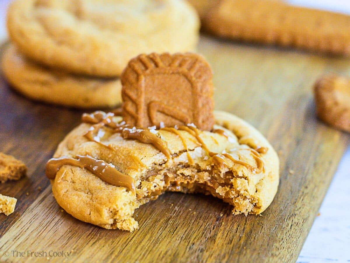 Biscoff cookie butter stufffed cookie with bite taken out, center oozing out.