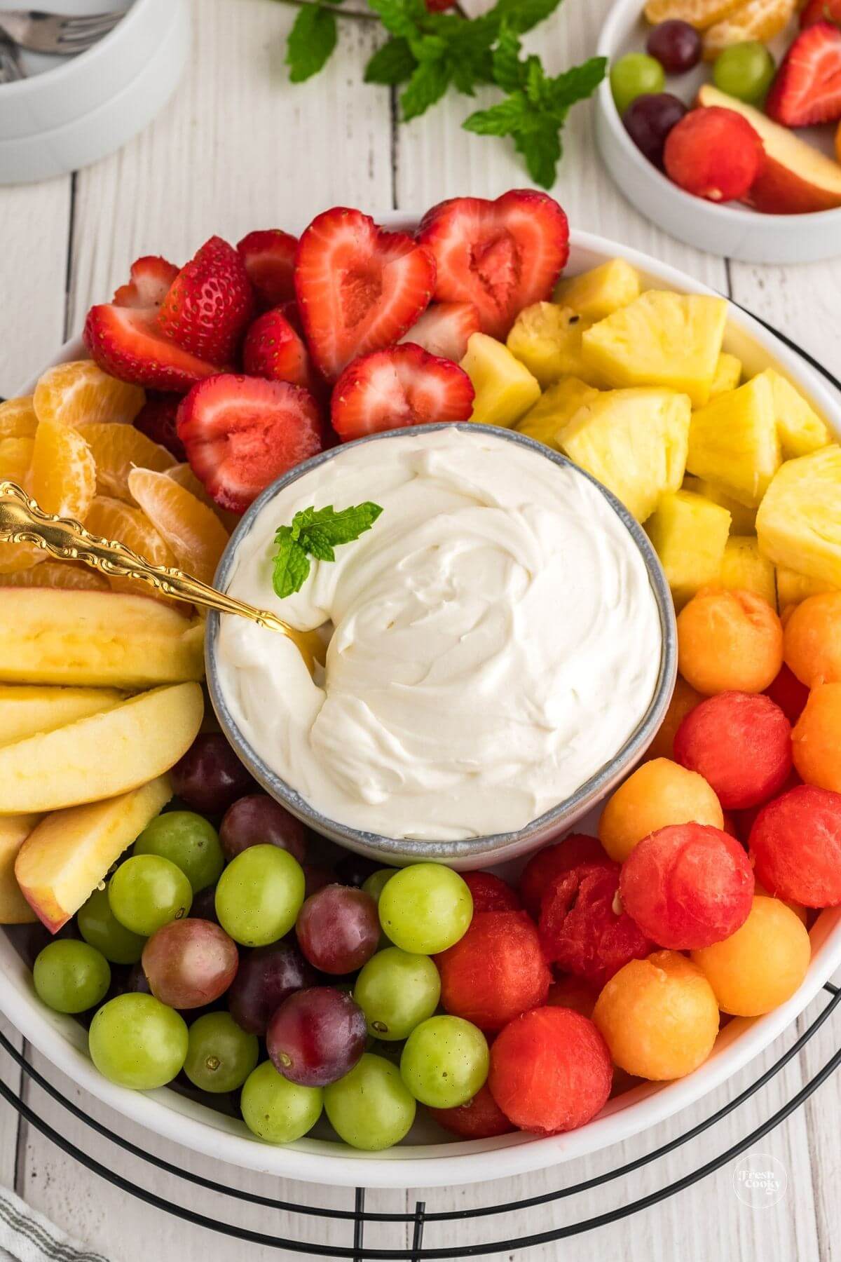 3 ingredient cream cheese fruit dip in bowl surrounded by fresh fruit.