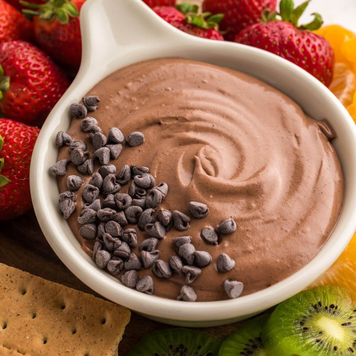 Best chocolate fruit dip recipe, 4 ingredients, with fruit surrounding.