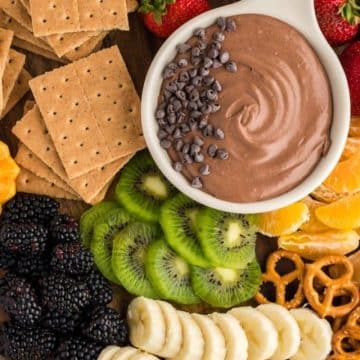 Chocolate fruit dip recipe with board of fruit and crackers.