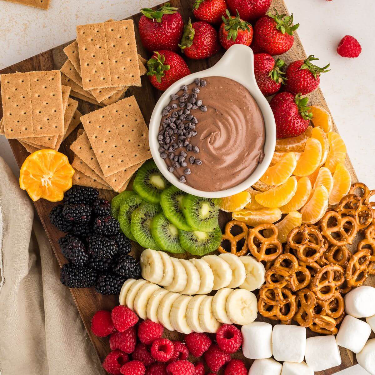 Chocolate fruit dip on board with loads of yummy dippers.