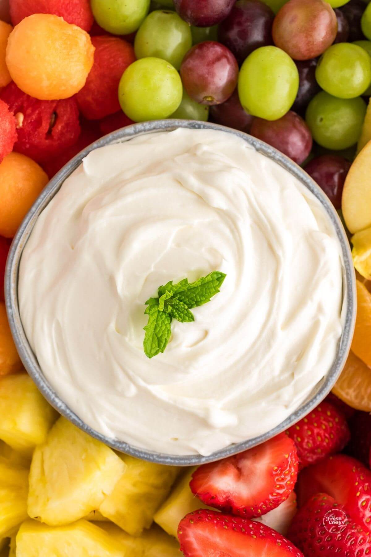 Close up of 3-ingredient fruit dip, lower in sugar, surrounded by fresh fruit.