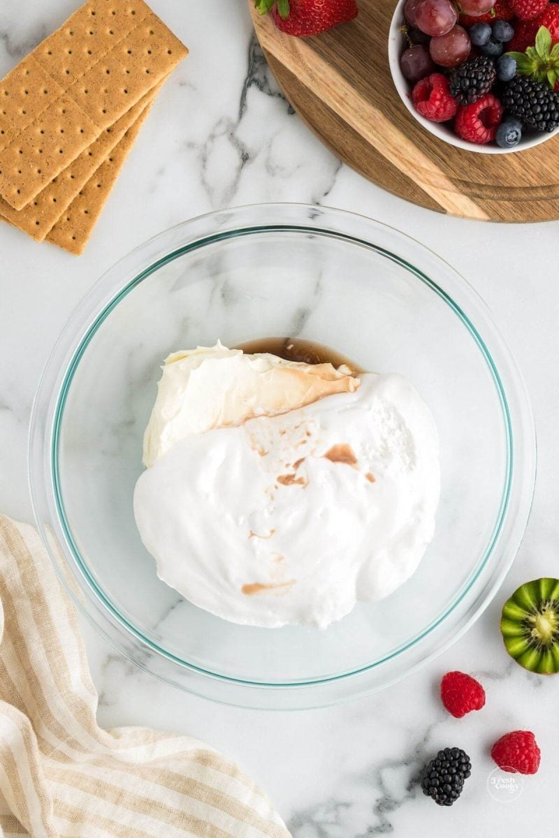 Marshmallow creme, cream cheese and vanilla in bowl. 