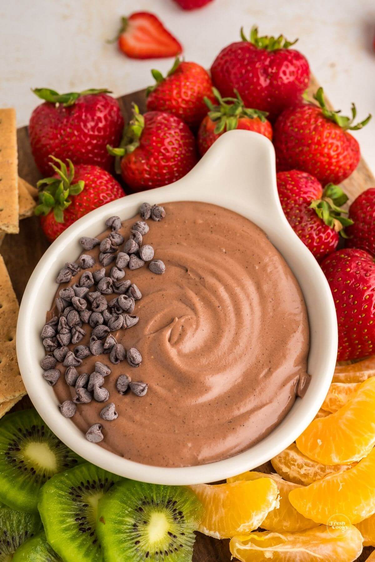 Dip with chocolate chips as a garnish on a fruit-filled board for dipping.