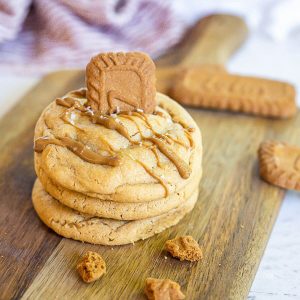 Biscoff stuffed cookie butter cookies stacked on a cutting board.