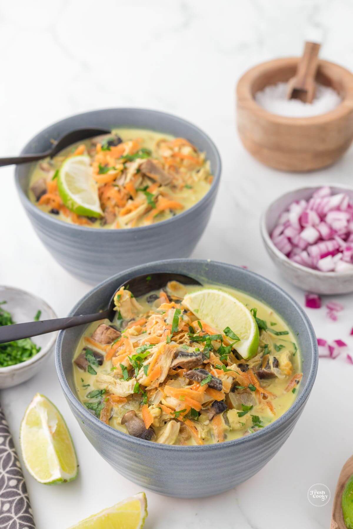 Two bowls of Thai coconut chicken soup.