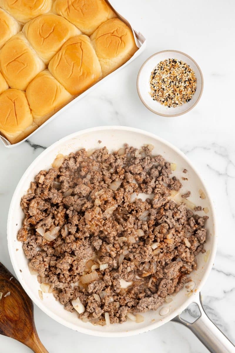 Browned ground beef and onions in pan for hamburger sliders. 