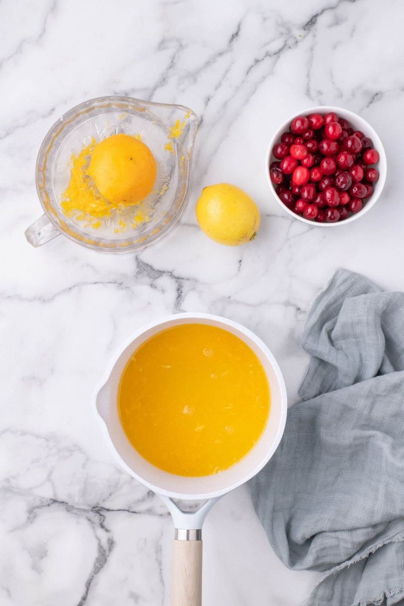 Simmer orange and lemon juices before adding cranberries. 