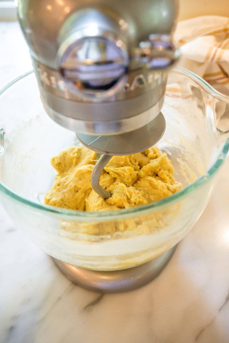Cinnamon roll dough in mixer with j hook for Apple Cinnamon Rolls.