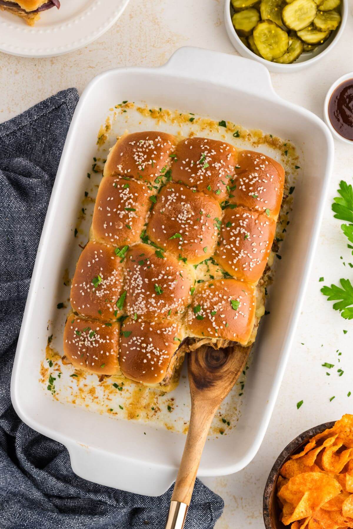 Casserole dish with connected Hawaiian roll Barbeque Chicken Sliders.