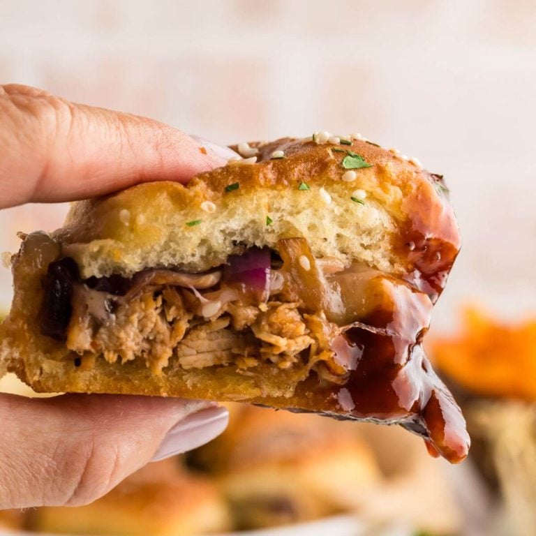 square image of someone holding a Barbeque Chicken Slider dripping barbeque sauce.