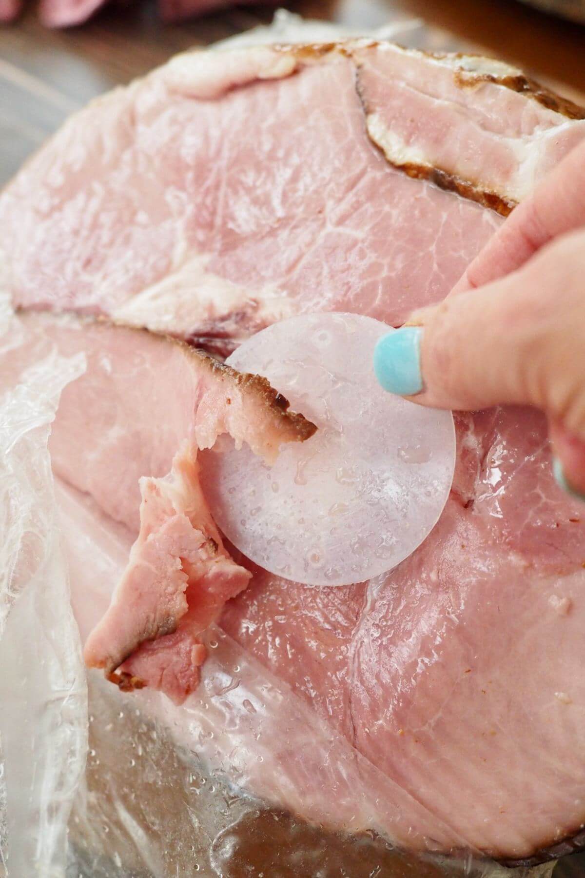 Removing plastic disc covering the ham bone.