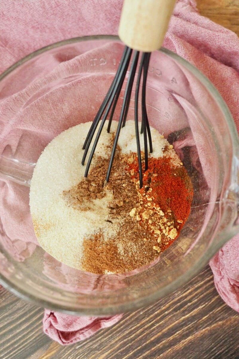 Whisk in bowl combining sugar and spices for glaze on ham.