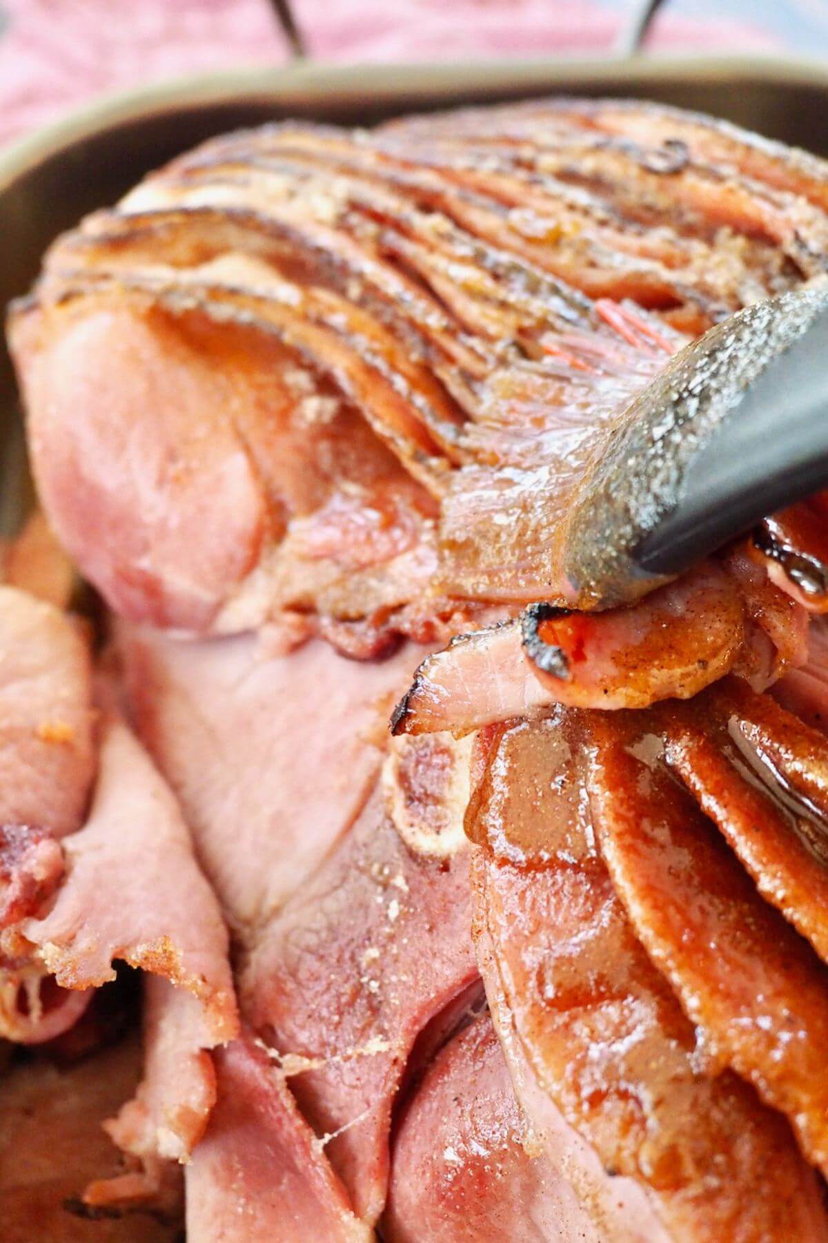 Brushing glaze over top of Costco spiral ham. 