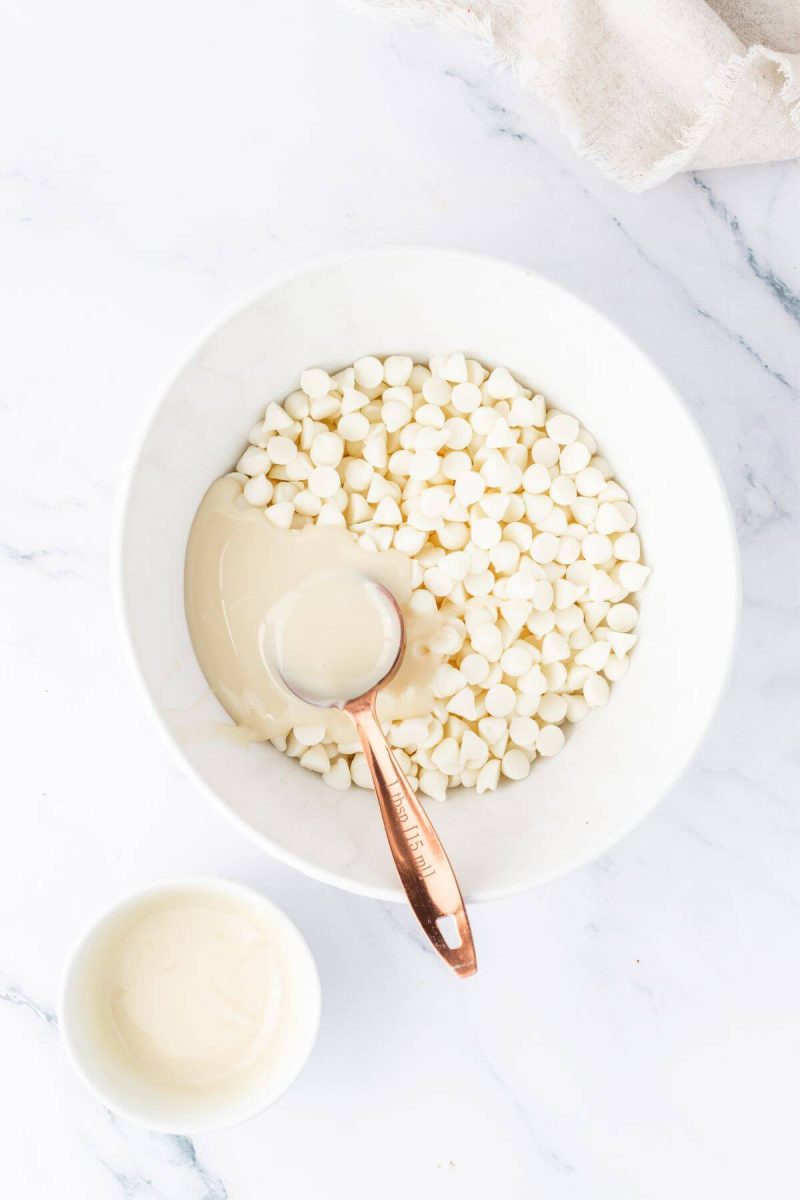 Add sweetened condensed milk to white chocolate chips in microwave safe bowl. 