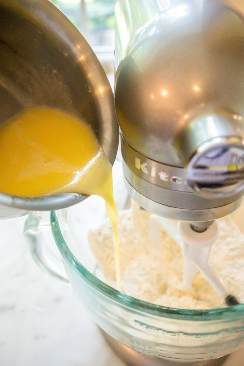 Pouring warmed butter, sugar and salt milk into dry ingredients. 