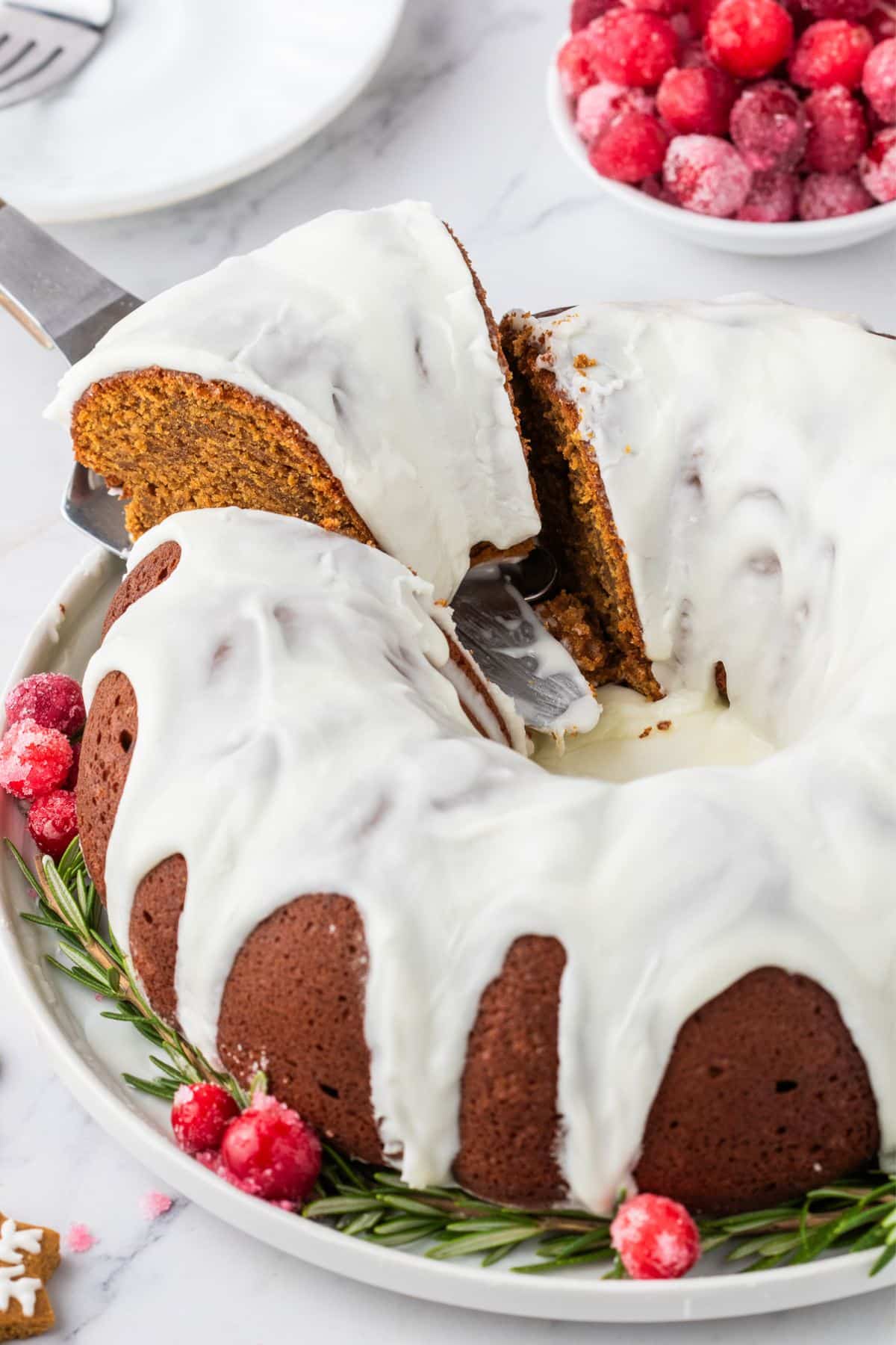 Pulling a slice of Gingerbread bundt cake from the whole cake.