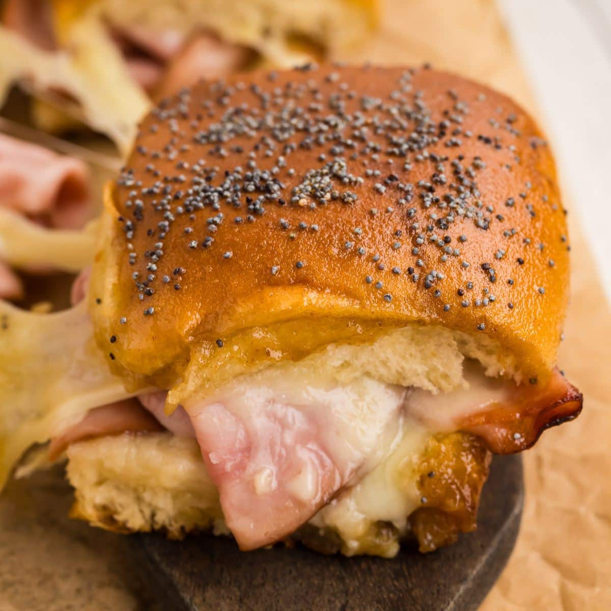 A gooey, cheesy, ham and cheese slider with Hawaiian rolls.