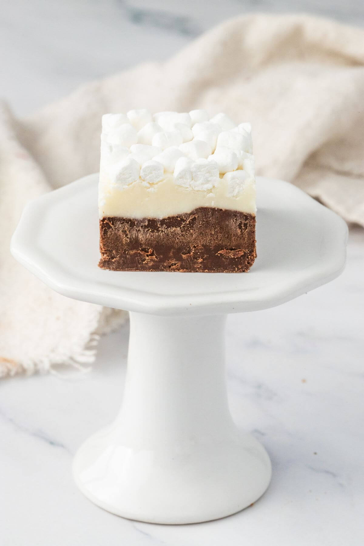 Hot Chocolate Fudge with marshmallows served on pedestal dish.