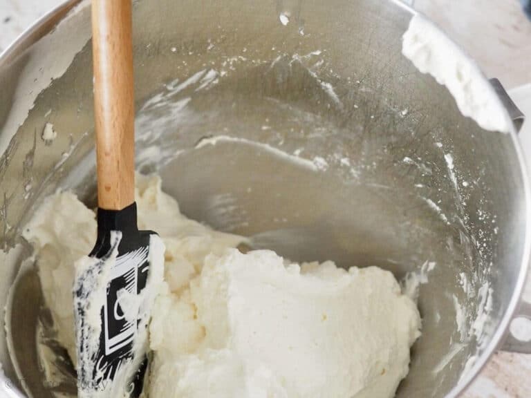 Folding homemade cool whip into cream cheese mixture.