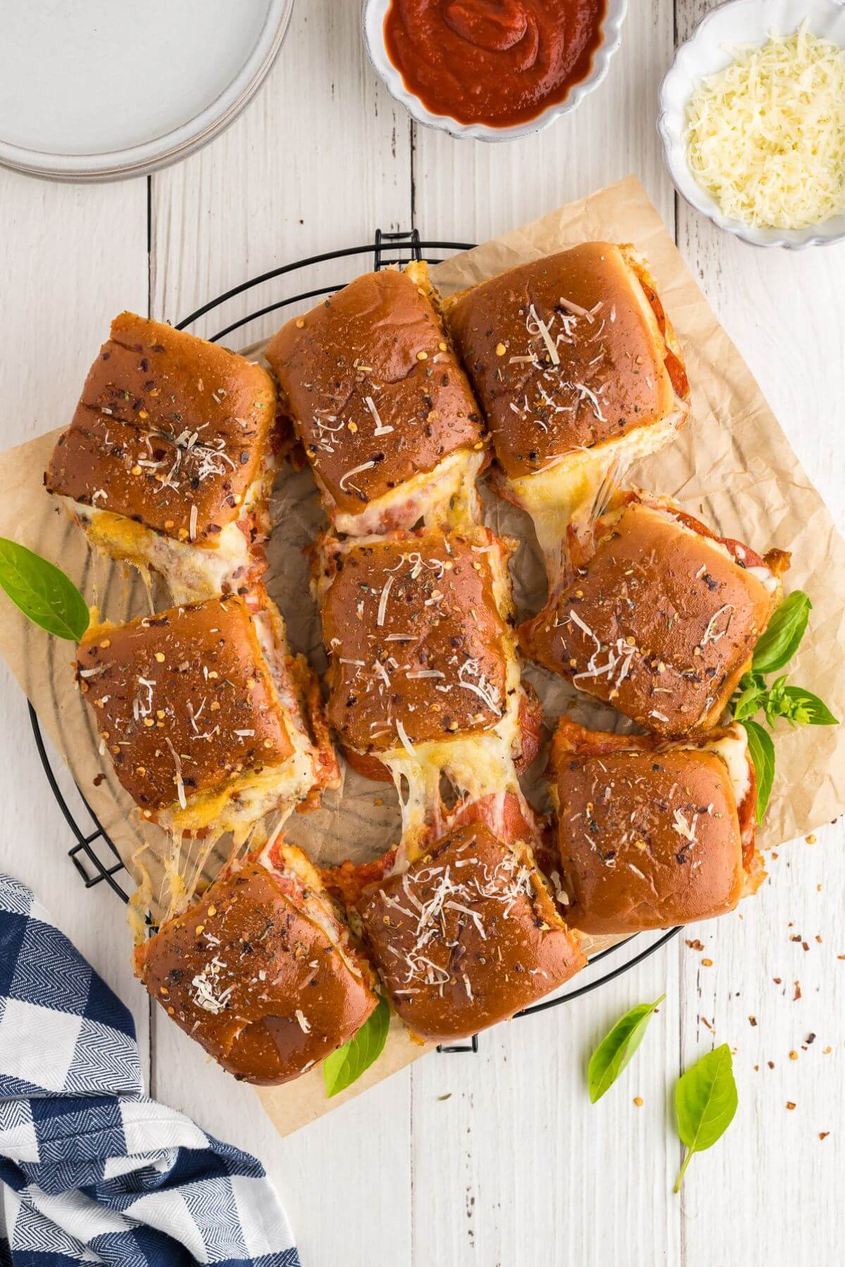 Pizza sliders on plate for serving with dipping sauce.