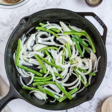 Saute the onions and green bell peppers in skillet.